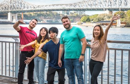 A Diverse group of international students smiling outside a Langports campus