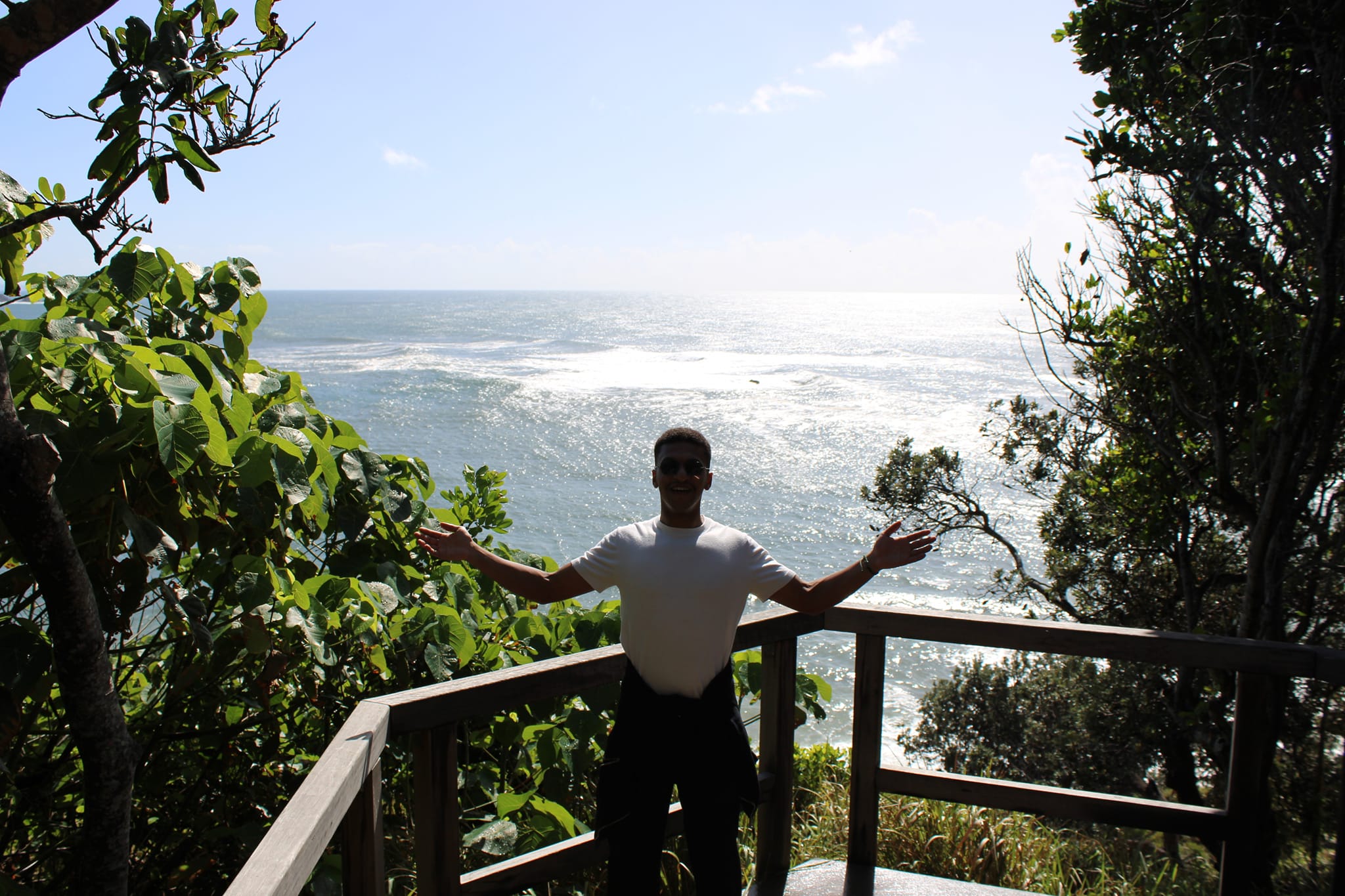 A happy student on a balcony learning English: English schools Gold Coast